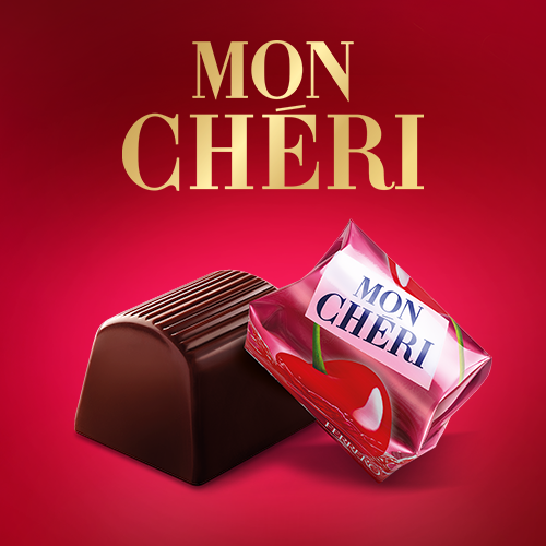 An unwrapped Mon Chéri chocolate beside a pink-wrapped piece on a red background