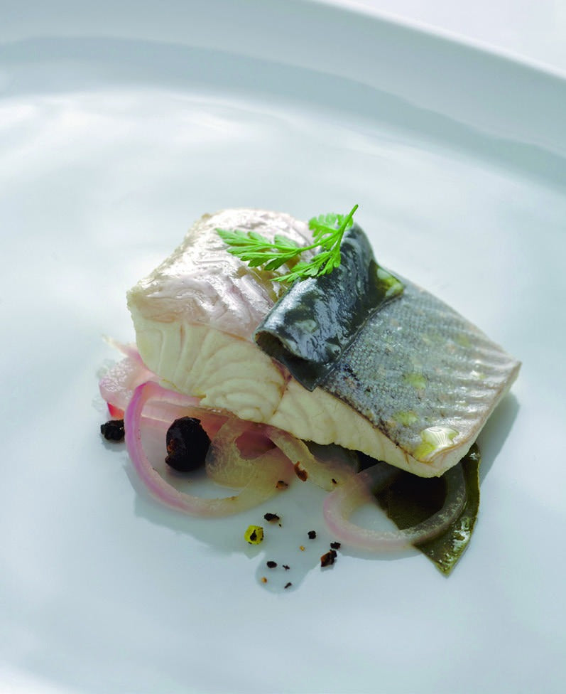 Trout au bleu poached in Grüner Veltliner stock with red onions