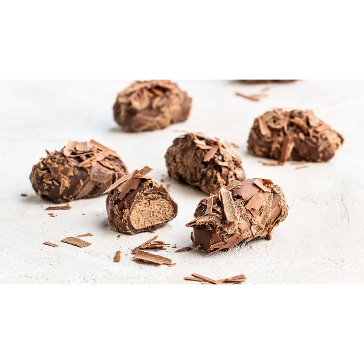 Duc d’O milk hazelnut flaked truffles with chocolate flakes and a cut-open truffle