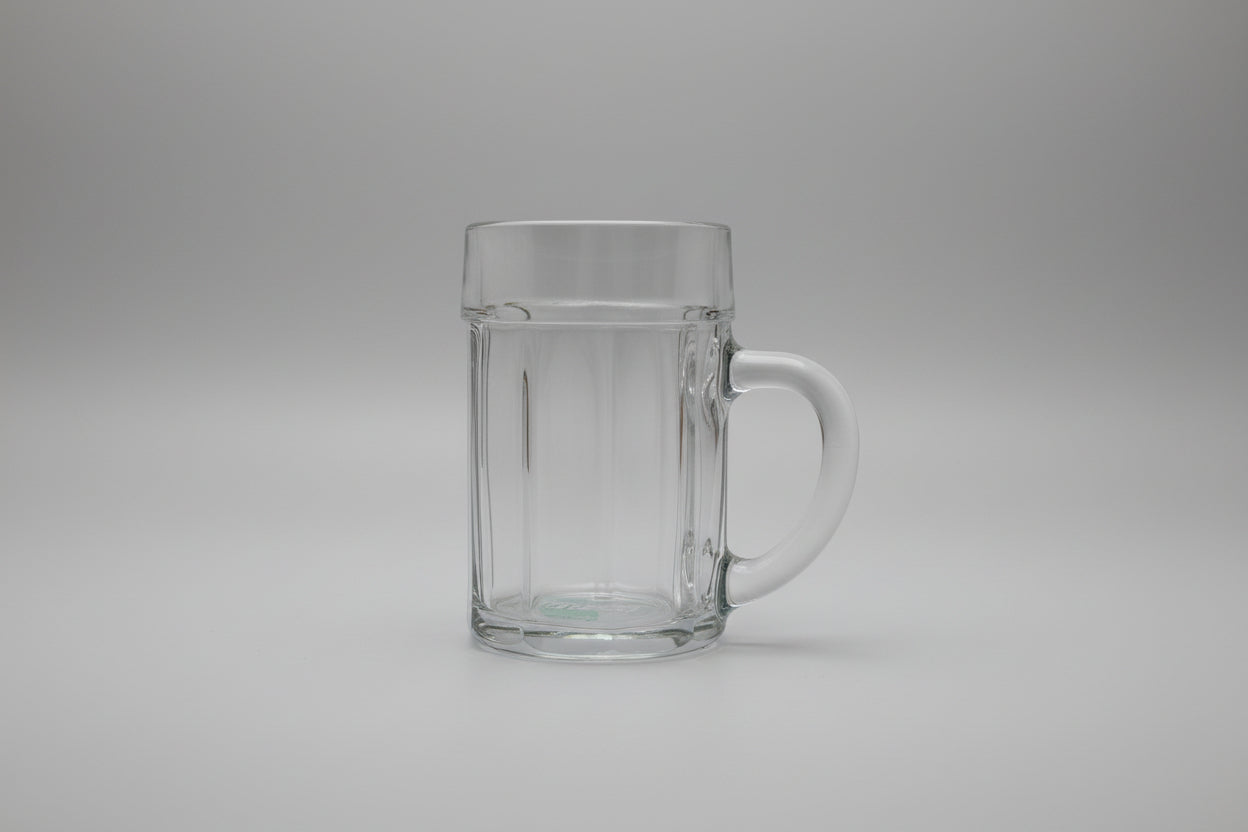 Clear glass mug with handle on a wooden surface