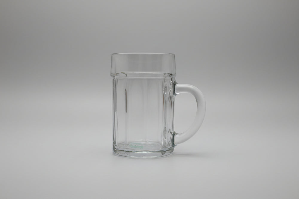 Clear glass mug with handle on a wooden surface