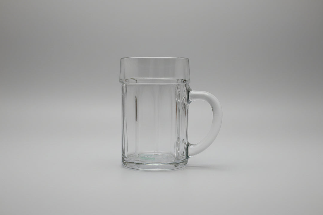 Clear glass mug with handle on a wooden surface
