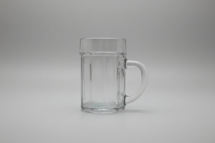 Clear glass mug with handle on a wooden surface