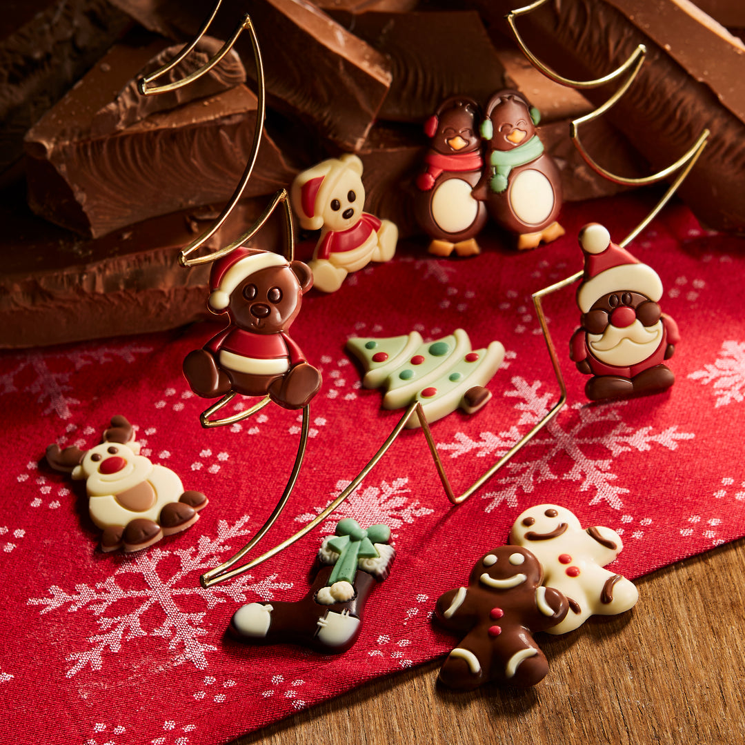 Ickx Christmas chocolates shaped like Santa, snowmen, reindeer and trees on a red cloth
