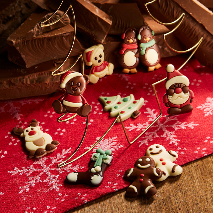 Ickx Christmas chocolates shaped like Santa, snowmen, reindeer and trees on a red cloth