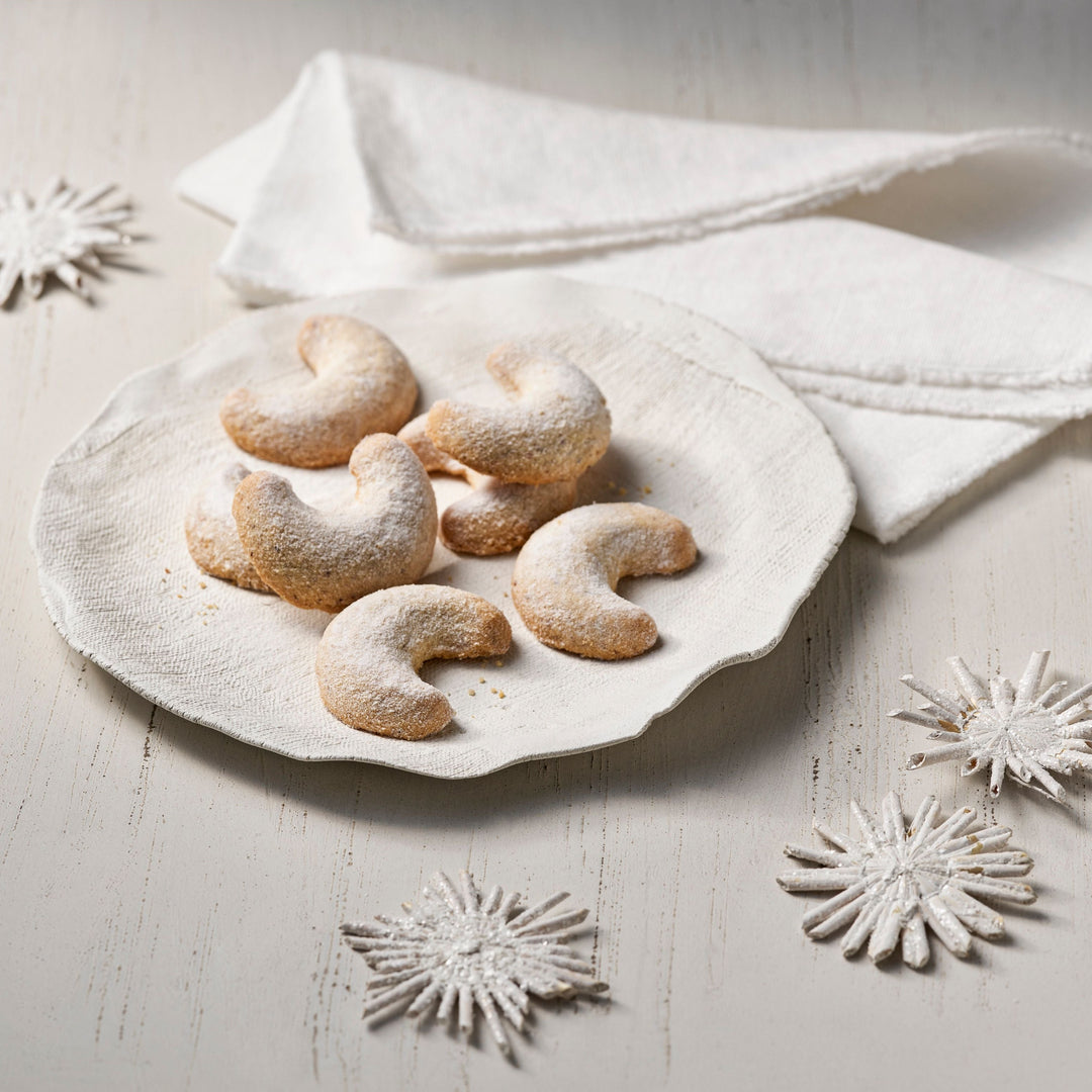 Lebkuchen Schmidt reduced-sugar vanilla crescent cookies on a white holiday table
