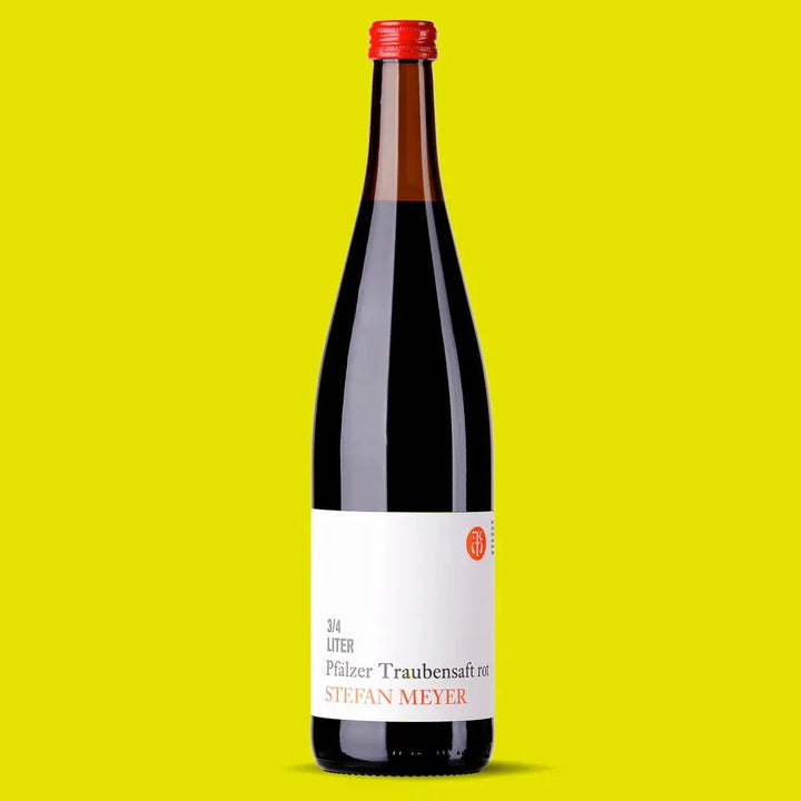 Stefan Meyer red grape juice, 750 ml bottle on a yellow background