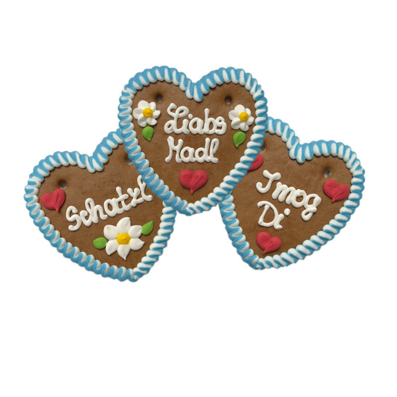 Three blue and white trimmed German gingerbread hearts