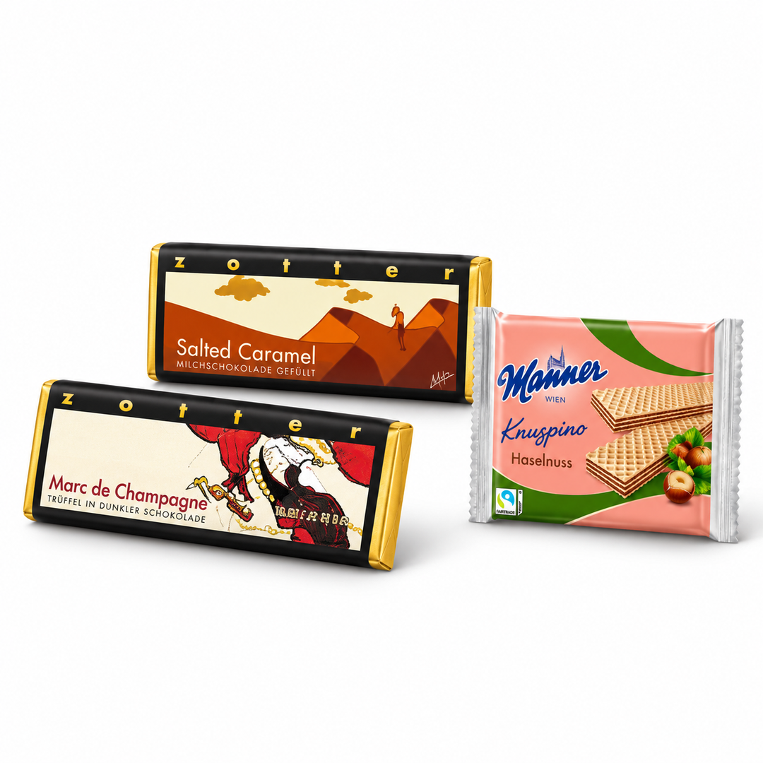 Best of Austria assortment with one Zotter Marc de Champagne bar, one Zotter Salted Caramel bar and one Manner Knuspino Hazelnut wafer packet on a white background