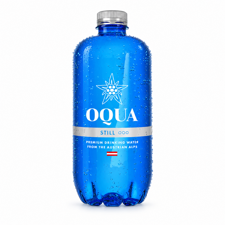 A blue plastic bottle of OQUA Still premium drinking water with a silver cap, covered in water droplets, on a white background with a reflection.