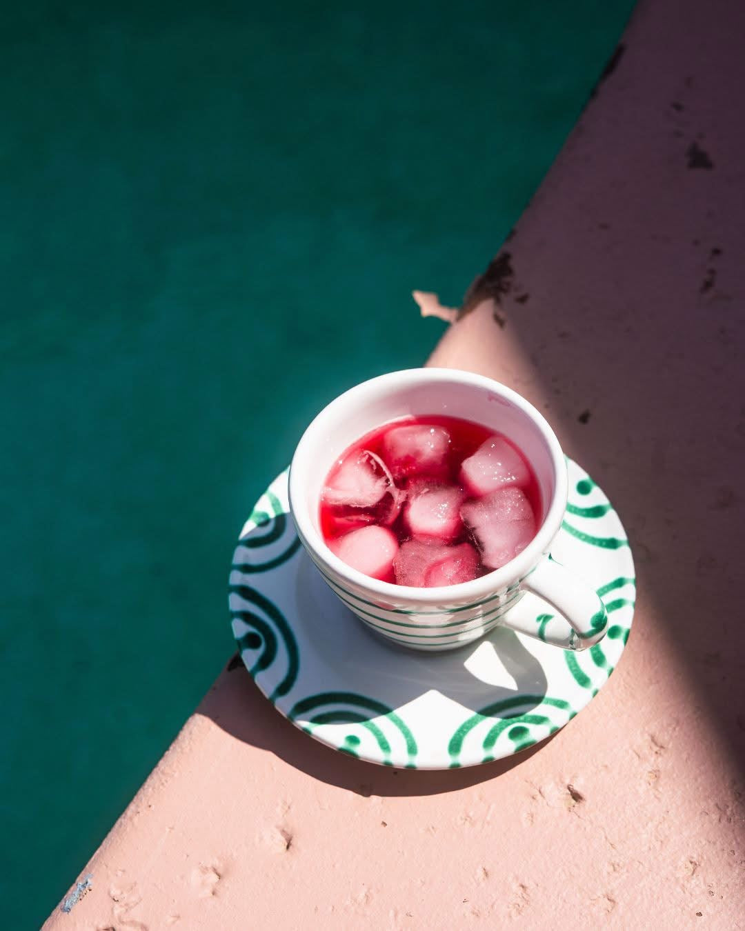 Green flamed saucer with a striped cup and iced drink; cup sold separately