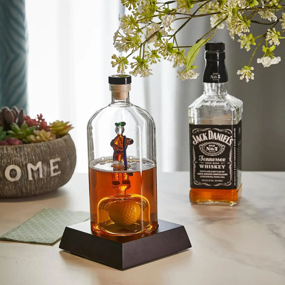 Khen golfer whiskey decanter displayed beside a whiskey bottle