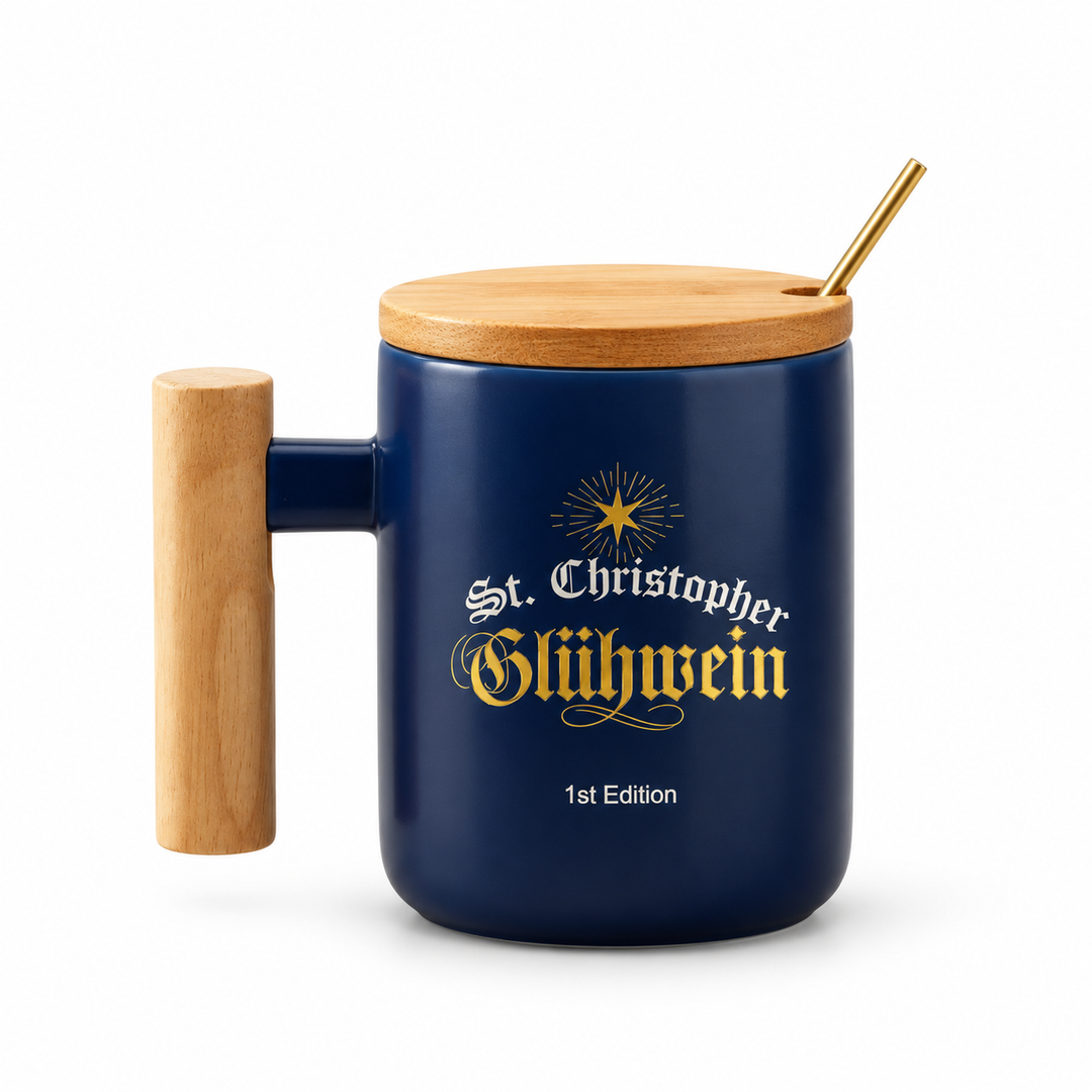 St. Christopher dark blue Gluehwein mug with gold lettering, wooden handle and lid, and gold spoon on a white background