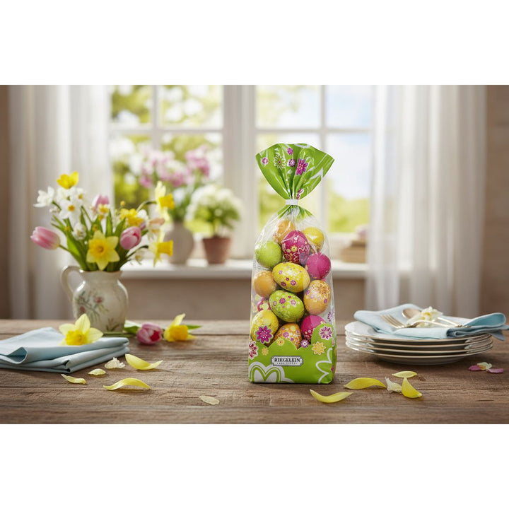 Packaged colorful Easter eggs with decorative paper on a white background