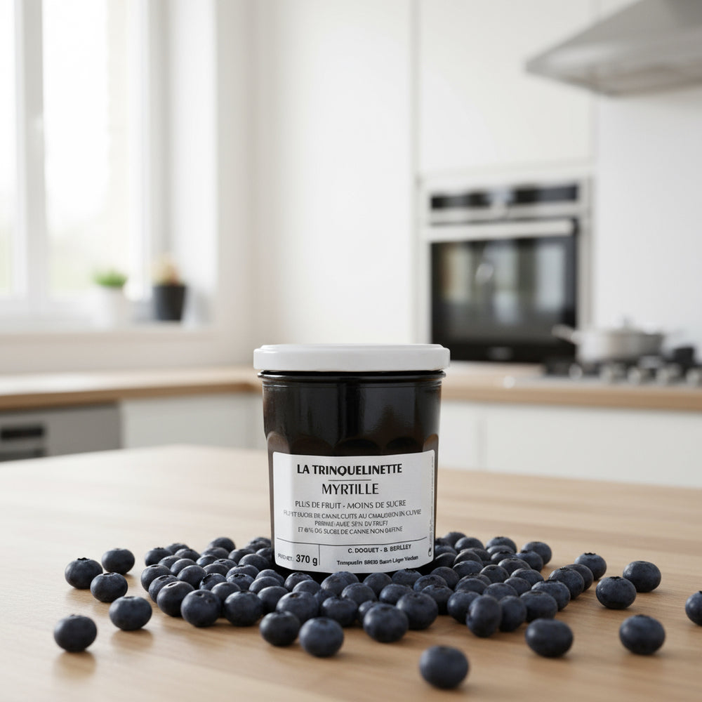 La Trinquelinette Blueberry Jam jar with blueberries in a kitchen scene
