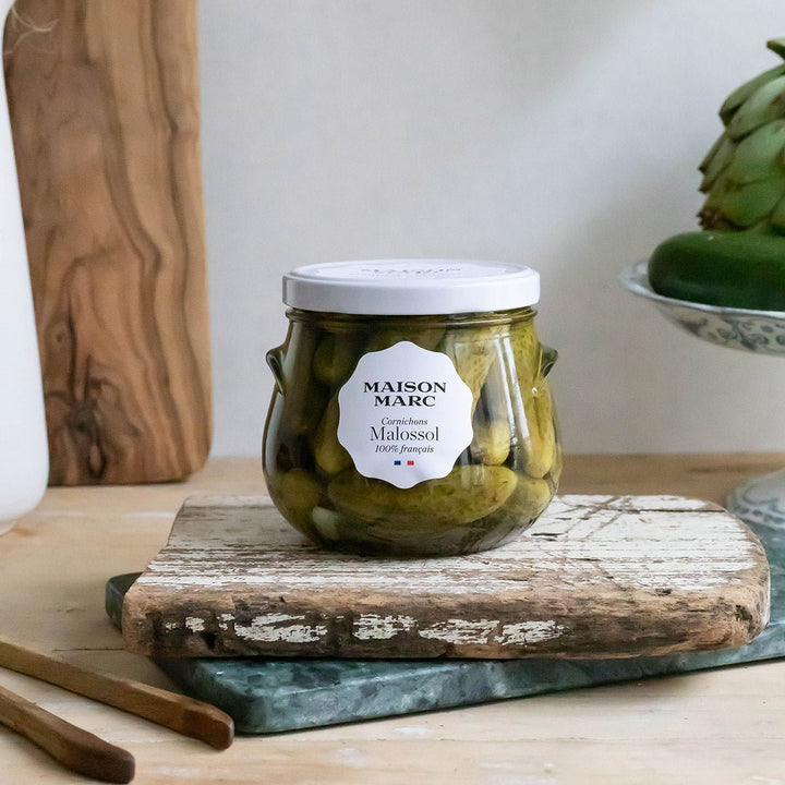 Maison Marc Cornichons Malossol 310 g jar on a rustic serving board