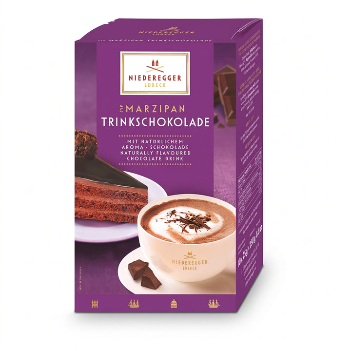 Niederegger chocolate packaging with a cup of hot chocolate and cake on a purple background