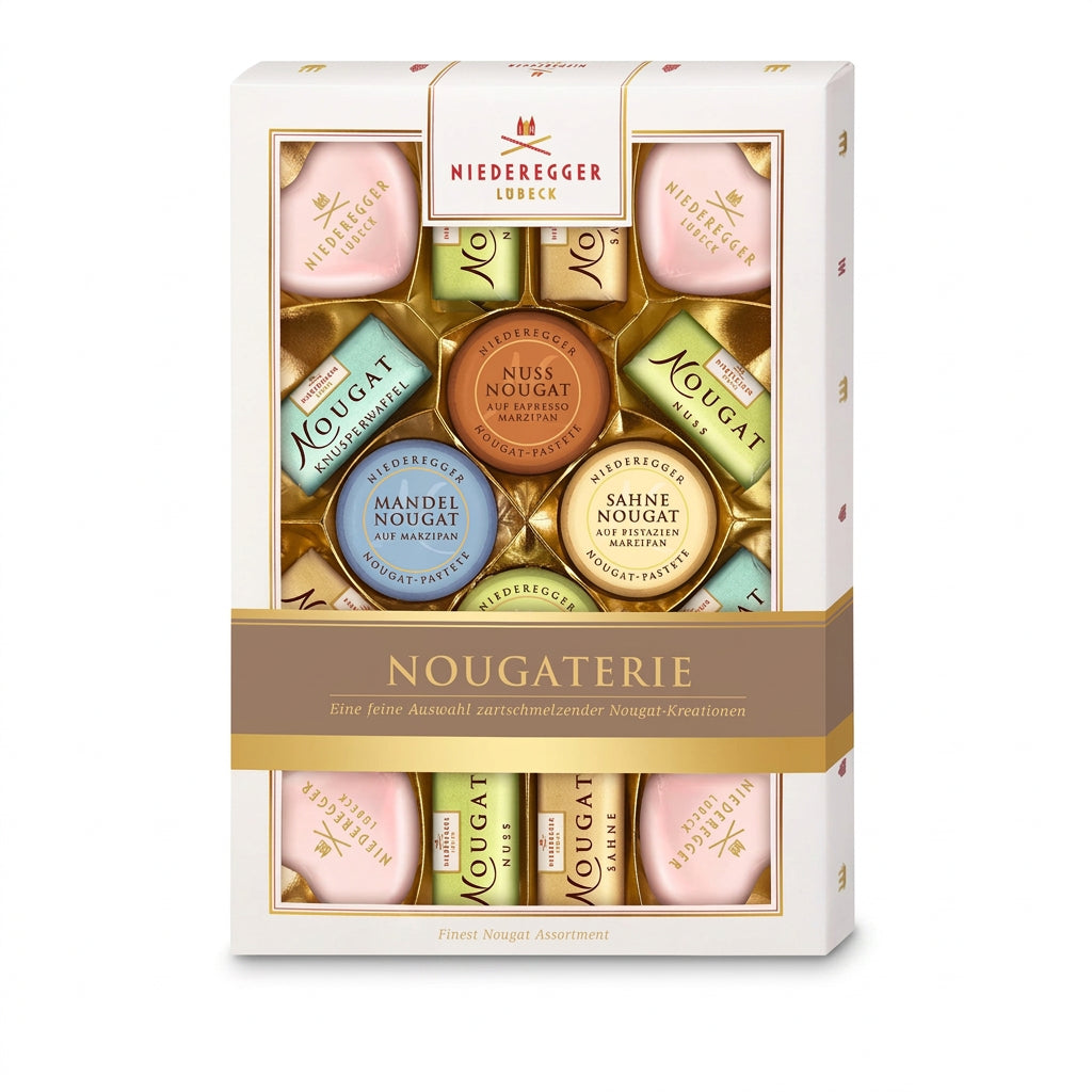 An elegant gift box of Niederegger Nougaterie, displaying an assortment of nougat mini loaves, hearts, and rounds in gold and brown colors, with the brand's logo and product names.